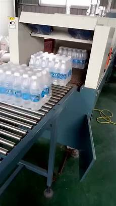 Shrink wrapping machine